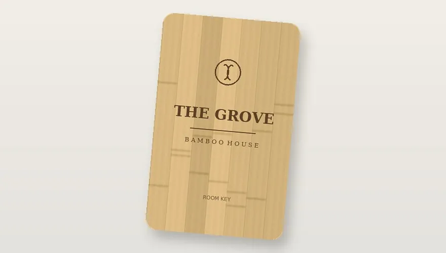 A finished carbonised-bamboo card with laser-engraved artwork — pressed from graded veneer stock.