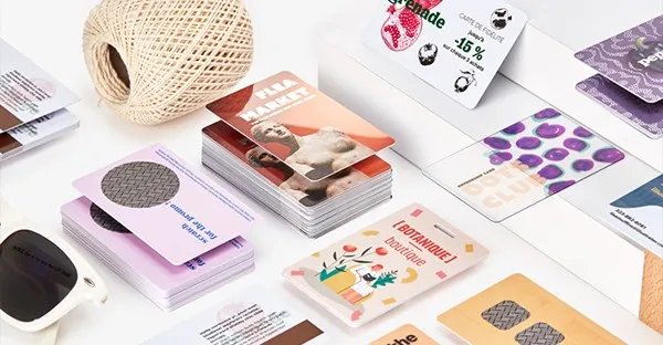 Waterproof paper cards straight off the press — full-colour offset print on a plastic-free body.